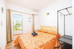 a bedroom with a bed and a large window at Gran Sol Family 5 in Felanitx +26 photos