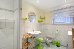 a bathroom with a sink and a toilet at Ferienwohnung Shaun in Blankenburg +20 photos