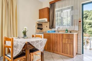 a kitchen with a table and a sink at Daratos studio 1 in Kefallonia +13 photos