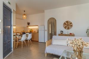 a living room with a couch and a table at Joan Serenity Apartment in Porto Heli