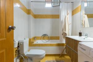a bathroom with a toilet and a sink and a tub at Joan Serenity Apartment in Porto Heli +17 photos
