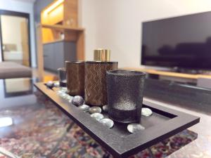 a table with two vases and balls on a table at Ferienwohnung In Der Grafschaft in Gelsdorf