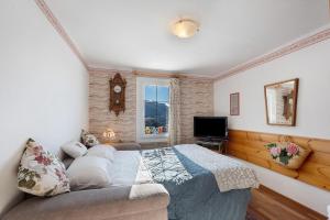 a bedroom with a bed and a tv in it at Casa Zarina Well-kept Two-room in Cavalese