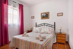 a bedroom with a bed with two towels on it at Casa Antonia 2 in Conil de la Frontera