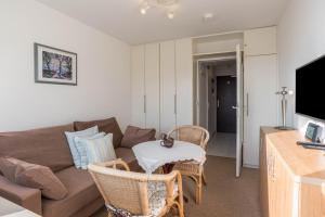 a living room with a couch and a table at Fewo Blick über Sylt in Westerland