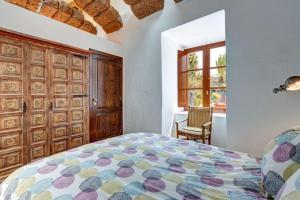 a bedroom with a bed and a window at Villa La Cueva in Teguise +26 photos