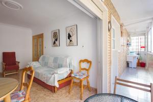 a living room with a bed and a table and chairs at Bonanza in Gandía