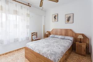 a bedroom with a large bed and a window at Bonanza in Gandía