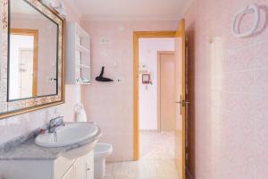 a bathroom with a sink and a mirror at Bonanza in Gandía +23 photos
