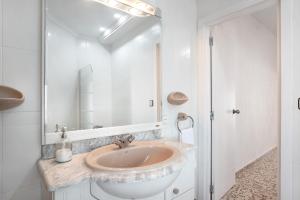 a bathroom with a sink and a mirror at Casa Rincón del Beso in Vejer de la Frontera +17 photos