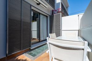 a balcony with a glass table and chairs at Casa Roc De Sant Gaietà in Roda de Bará
