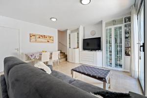 a living room with a couch and a table at Casa Roc De Sant Gaietà in Roda de Bará