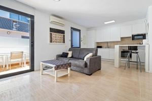 a living room with a couch and a table at Casa Roc De Sant Gaietà in Roda de Bará