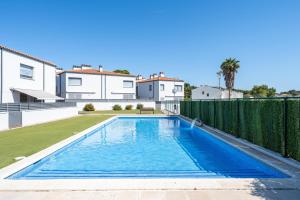 a swimming pool in the backyard of a house at Casa Roc De Sant Gaietà in Roda de Bará