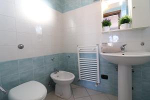 a bathroom with a sink and a toilet and a mirror at Casa vacanze Frida in Salento in Otranto