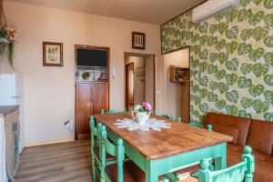 a dining room with a green table and chairs at Da Susy - Aria condizionata in Pescia