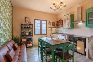 a kitchen with a table and a couch at Da Susy - Aria condizionata in Pescia +15 photos