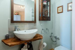 a bathroom with a white sink and a mirror at Da Susy - Aria condizionata in Pescia