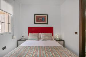 a bedroom with a large bed with a red headboard at Paraíso Radazul in Radazul +22 photos