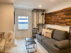 a living room with a couch and a brick wall at Ferienwohnung Nele in Plettenberg