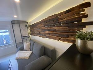 a living room with a couch and a wooden wall at Ferienwohnung Nele in Plettenberg