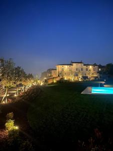 a view of a building at night with lights at Residence Palmento in Franciacorta in Corte Franca