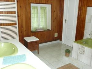 a bathroom with a sink and a mirror at Suite familiale - Gîte du Moulin in La Noue