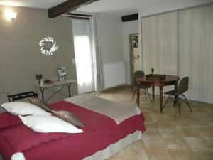 a bedroom with a large bed and a table at Suite familiale - Gîte du Moulin in La Noue