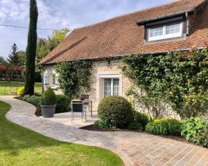 a brick house with a walkway in front of it at Suite familiale - Gîte du Moulin in La Noue