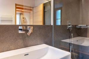 a bathroom with a white sink and a mirror at Egger an der Lahn - Apt Nonna in San Genesio Atesino +18 photos