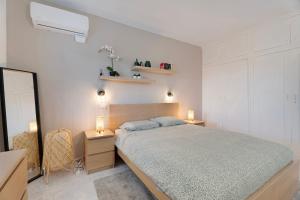 a bedroom with a bed and two tables and a mirror at Casa Noa in Costa Del Silencio +16 photos
