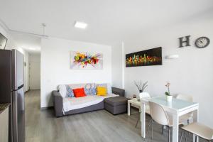 a living room with a couch and a table at Beautiful Apartment 1115 Central in San Bartolomé