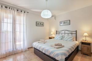 a bedroom with a large bed with two towels on it at Los Albatros in Ayamonte +14 photos