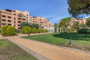 a walkway in a park in front of a building at Los Albatros in Ayamonte