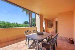a patio with a table and chairs on a balcony at Los Albatros in Ayamonte