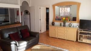 a living room with a couch and a television at Salvaje Villa with private Pool in Adeje
