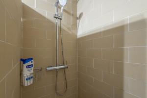 a shower with a shower head in a bathroom at Mayor 10 in Ejulve +17 photos