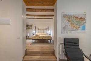 a bedroom with a bed and a map on the wall at Mayor 10 in Ejulve