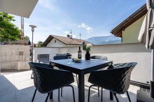 a black table and chairs on a patio at Videre Lodge Gantkofel in Gargazzone