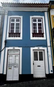 a blue and white house with two doors at Desterro House in Angra do Heroísmo +4 photos
