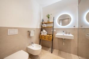 a bathroom with a toilet and a sink and a mirror at Videre Lodge Gantkofel in Gargazzone +31 photos