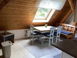 a dining room with a table and chairs and a window at Ferienwohung zum Wasserfall in Üxheim