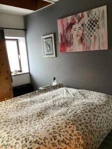 a bedroom with a bed and a painting on the wall at Ferienwohung zum Wasserfall in Üxheim