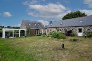 a stone house with a large yard in front of it at Ty Koad in Plouégat-Moysan