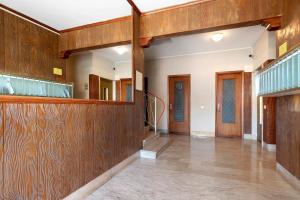 an empty hallway with wood paneling and a mirror at Maison Giovanna with garage parking in Rapallo