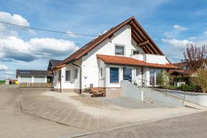 a white house with a brown roof at Arnold Laubbach in Ostrach