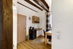 a small kitchen with a table and a refrigerator at Traumschlüsselchen in Braubach