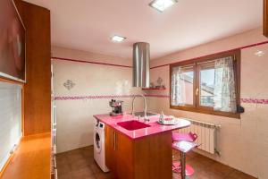 a bathroom with a pink sink and a washing machine at Casa Rural Alojamientos Marte in Hinojedo +22 photos