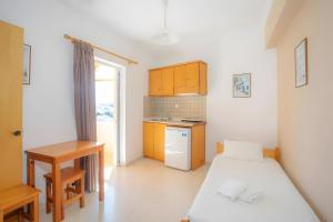 a small room with a bed and a kitchen at Nidri view Apartments in Nydri +94 photos