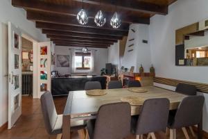 a dining room with a wooden table and chairs at Casa Rural Alojamientos Marte in Hinojedo